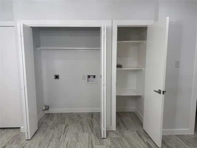 a view of walk in closet with wooden floor