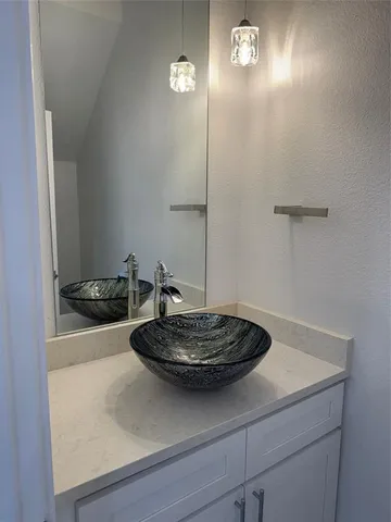 a close view of a sink a stove and dishwasher with wooden floor