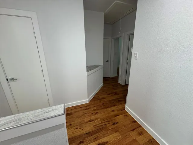 a view of hallway with wooden floor