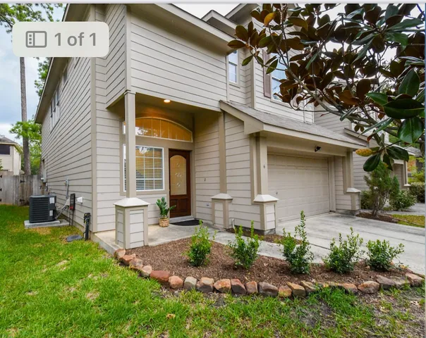a front view of a house with garden and patio