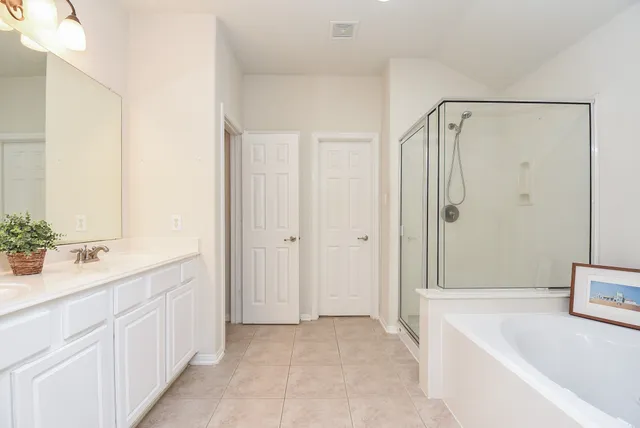 a en suite bathroom with a toilet sink and mirror