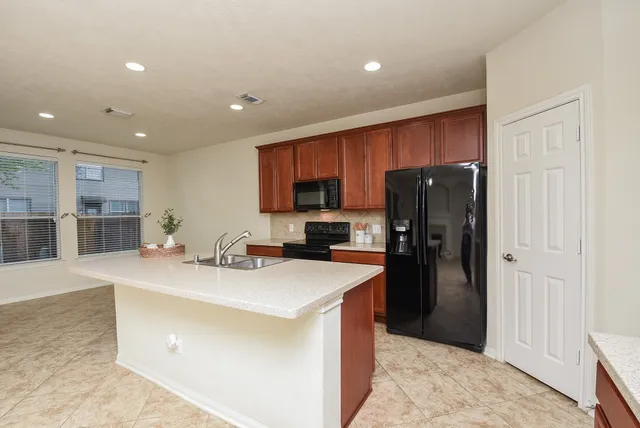 a kitchen with a refrigerator a sink and dishwasher