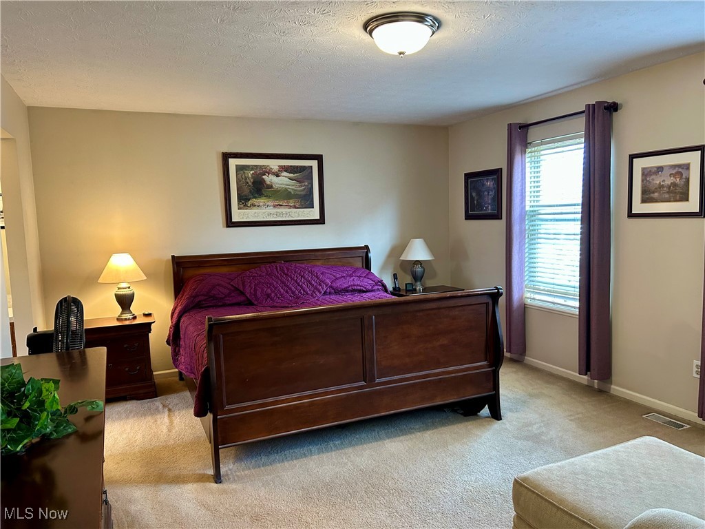 4420 Archer Road Cleveland, OH 44105 - Photo 6 of 18 Bedroom with light carpet and a textured ceiling