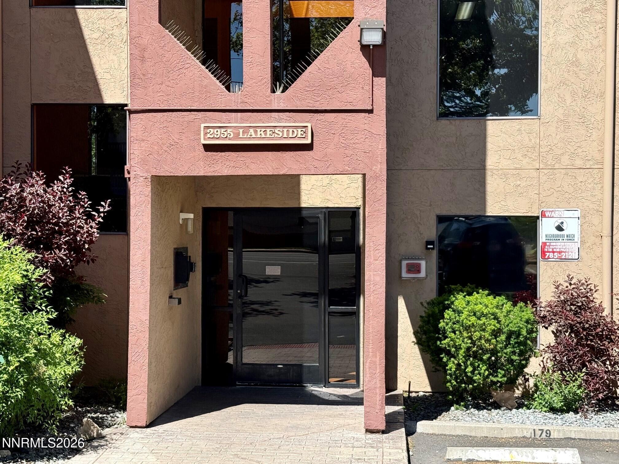 a view of front door and potted plants