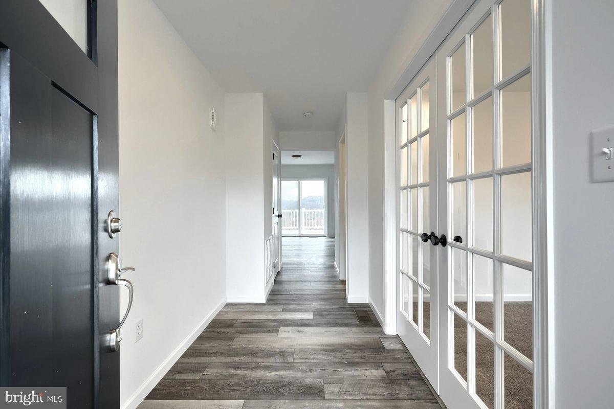 151 Redbud Road Bellefonte, PA 16823 - Photo 2 of 8 a view of a hallway with wooden floor and staircase