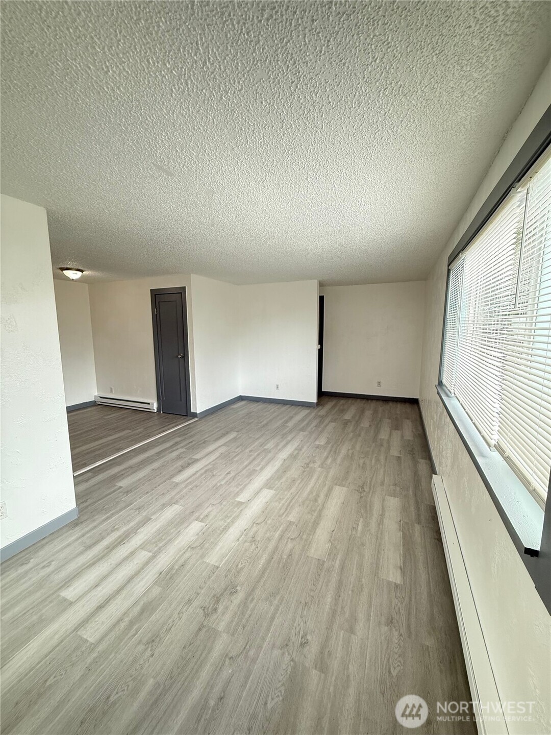 1007 MacFarlane Street Aberdeen, WA 98520 - Photo 16 of 23 a view of empty room with wooden floor and fan