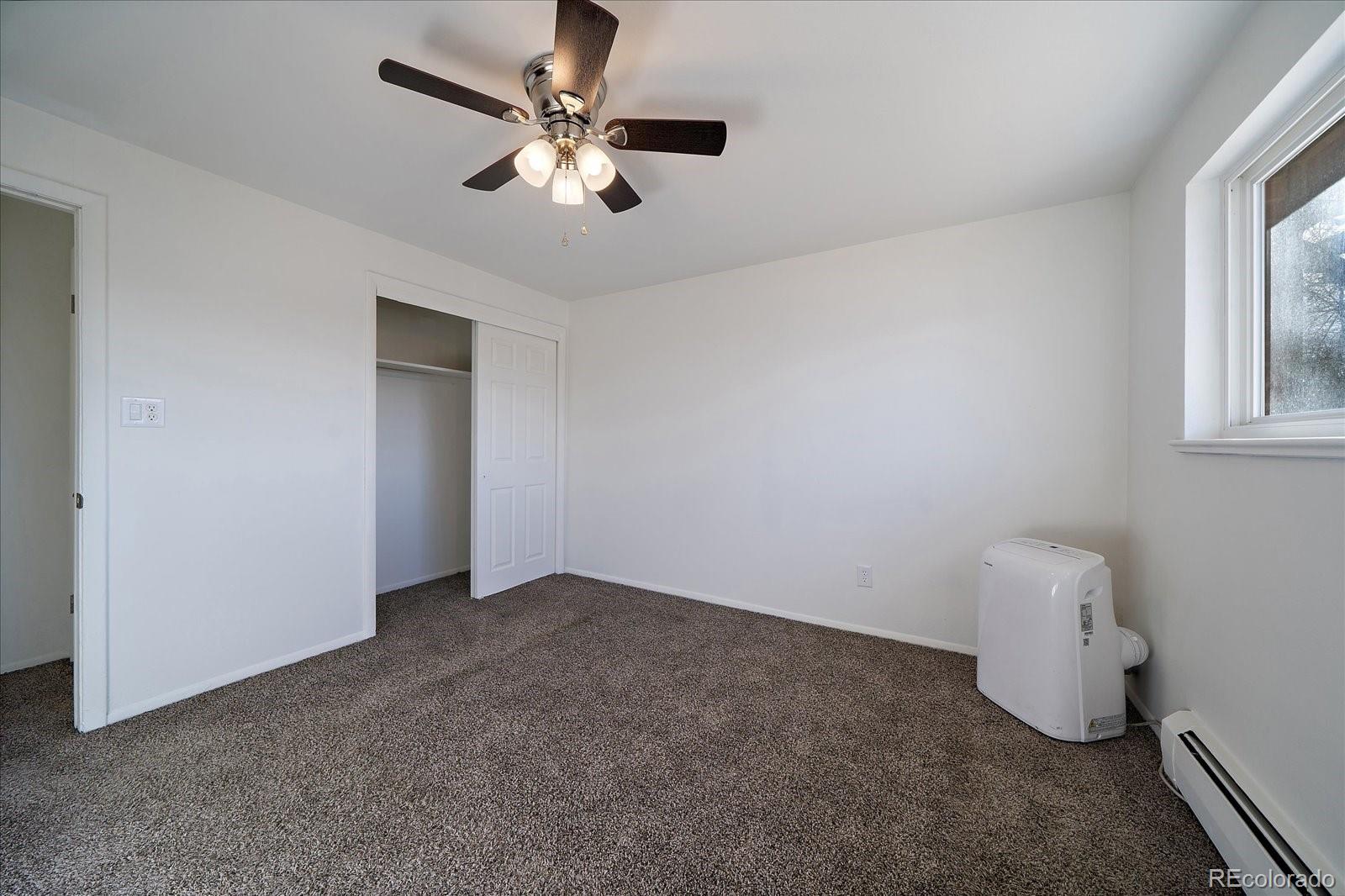 3738 Miller Court Wheat Ridge, CO 80033 - Photo 11 of 20 wooden floor in an empty room with a window