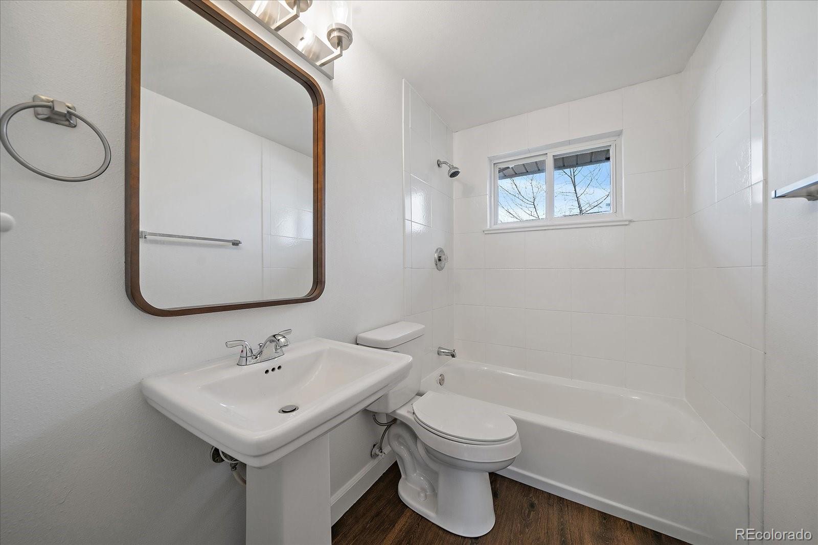 3738 Miller Court Wheat Ridge, CO 80033 - Photo 12 of 20 a bathroom with a toilet sink and mirror