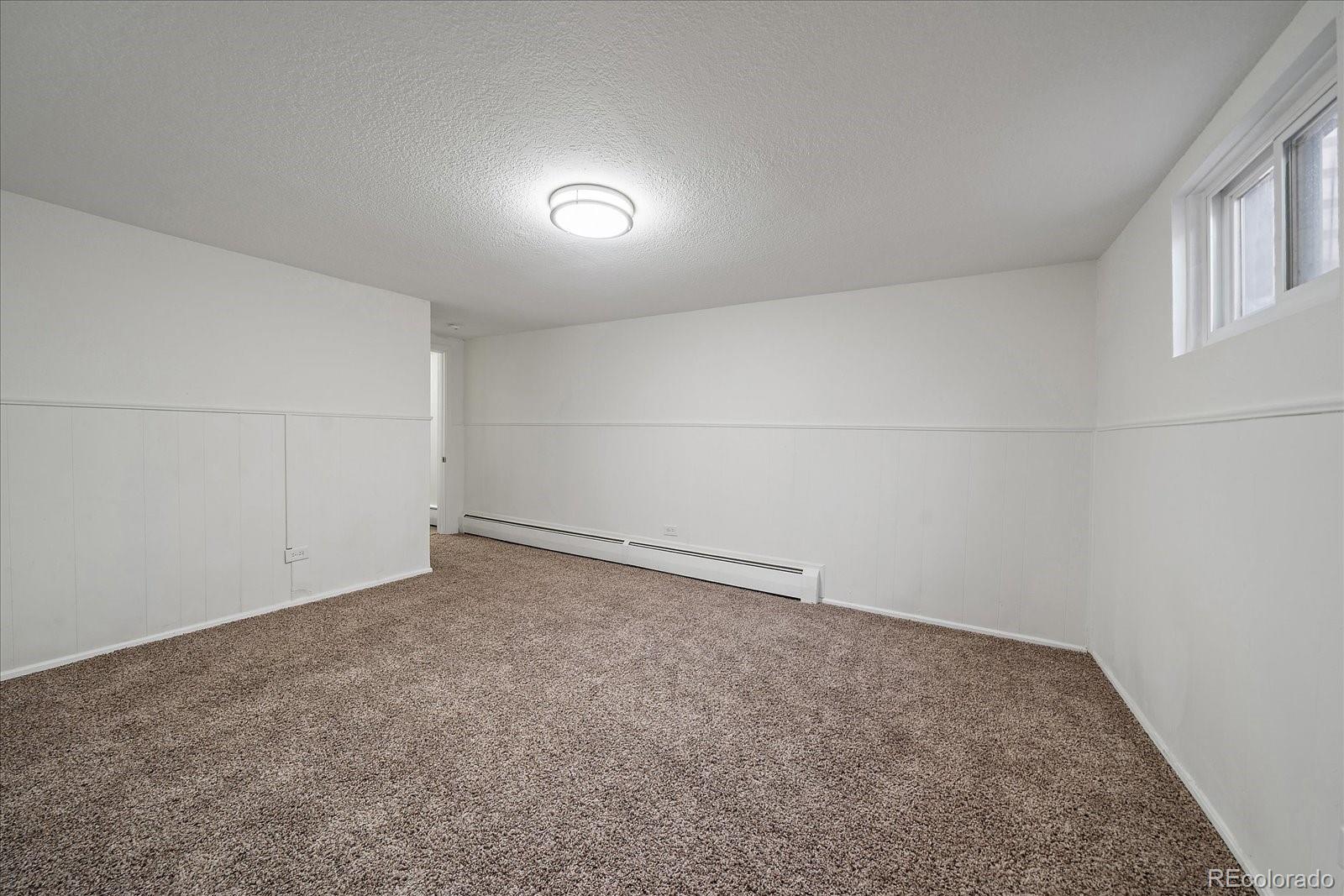 3738 Miller Court Wheat Ridge, CO 80033 - Photo 14 of 20 an empty room with a natural light