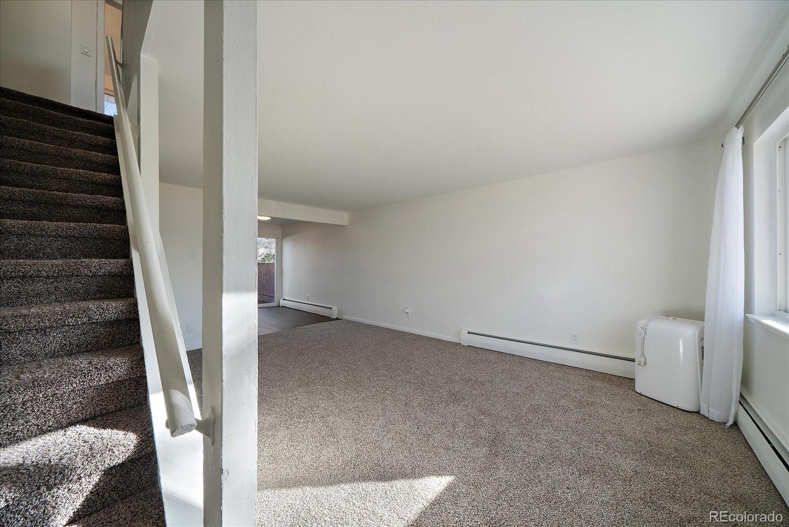 3738 Miller Court Wheat Ridge, CO 80033 - Photo 3 of 20 a view of an empty room with stairs