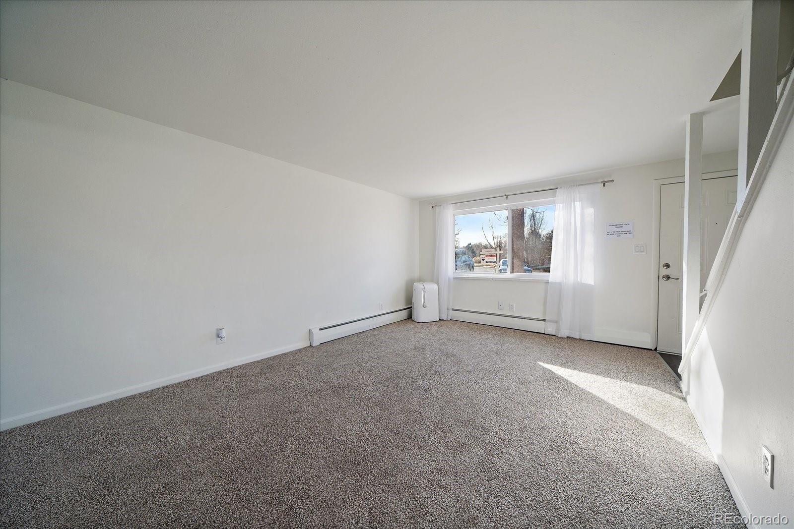 3738 Miller Court Wheat Ridge, CO 80033 - Photo 4 of 20 an empty room with windows