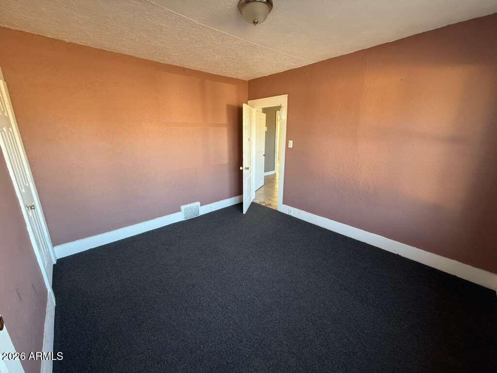 1165 East 10th Street, Unit 3 Douglas, AZ 85607 - Photo 12 of 22 an empty room with a door