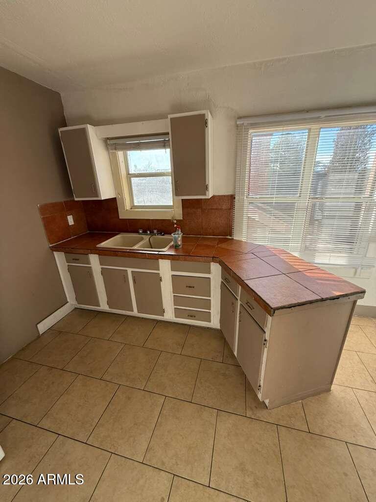 1165 East 10th Street, Unit 3 Douglas, AZ 85607 - Photo 6 of 22 a kitchen with a cabinets and a stove top oven