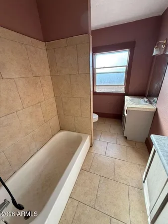 a bathroom with a bathtub and toilet