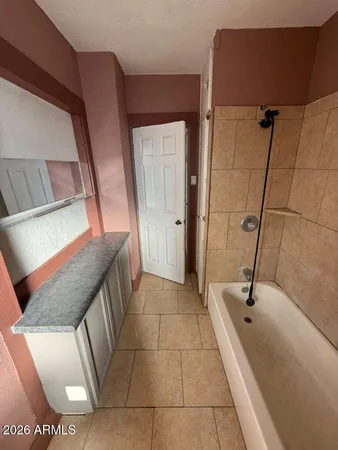 a bathroom with a granite countertop sink a toilet and mirror