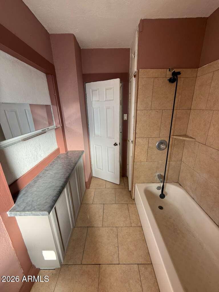 1165 East 10th Street, Unit 3 Douglas, AZ 85607 - Photo 9 of 22 a bathroom with a granite countertop sink a toilet and mirror