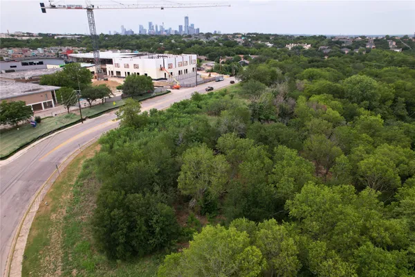 a view of a city with lush green forest