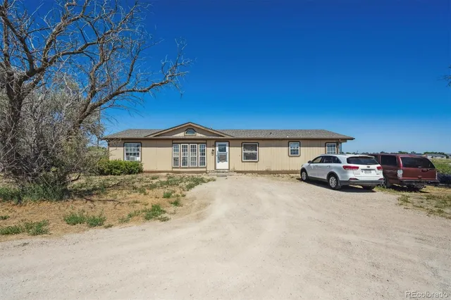 a view of a car parked in front of a house