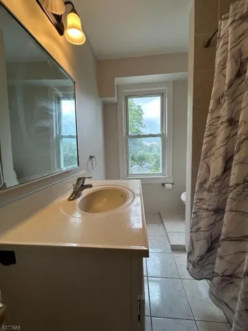 a view of bathroom with a sink and mirror
