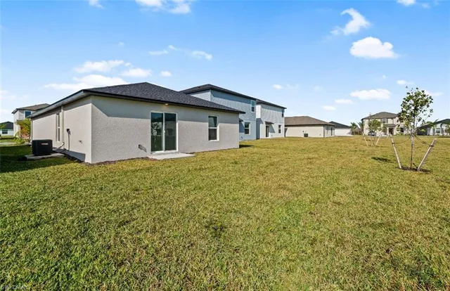 a view of a house with a yard and garage