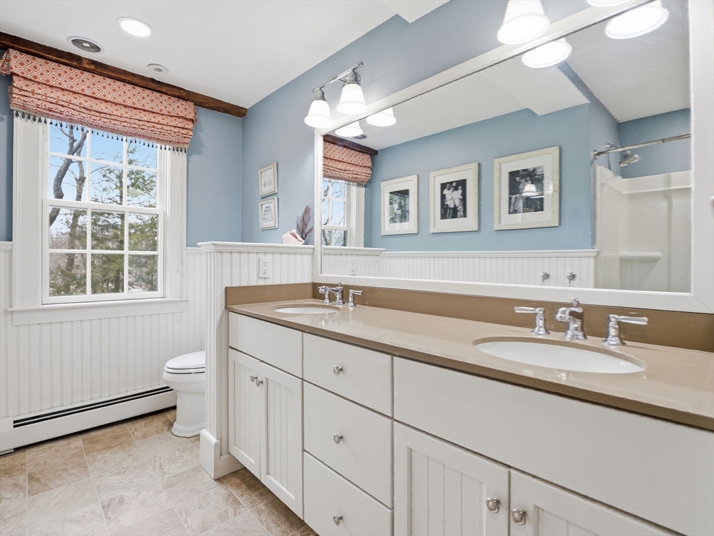 49 Salem Street Andover, MA 01810 - Photo 26 of 39 a bathroom with a toilet a sink a mirror a window and vanity
