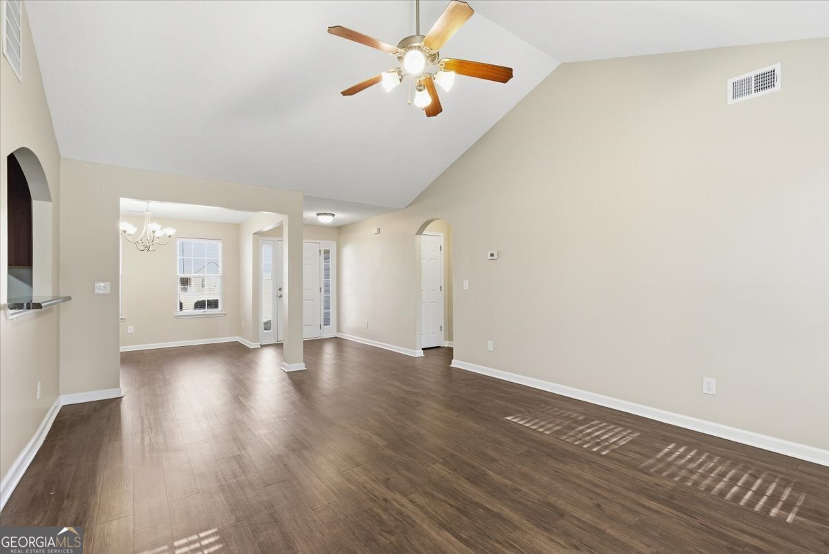 946 Damson Trail Hampton, GA 30228 - Photo 11 of 37 a view of an empty room with window and wooden floor