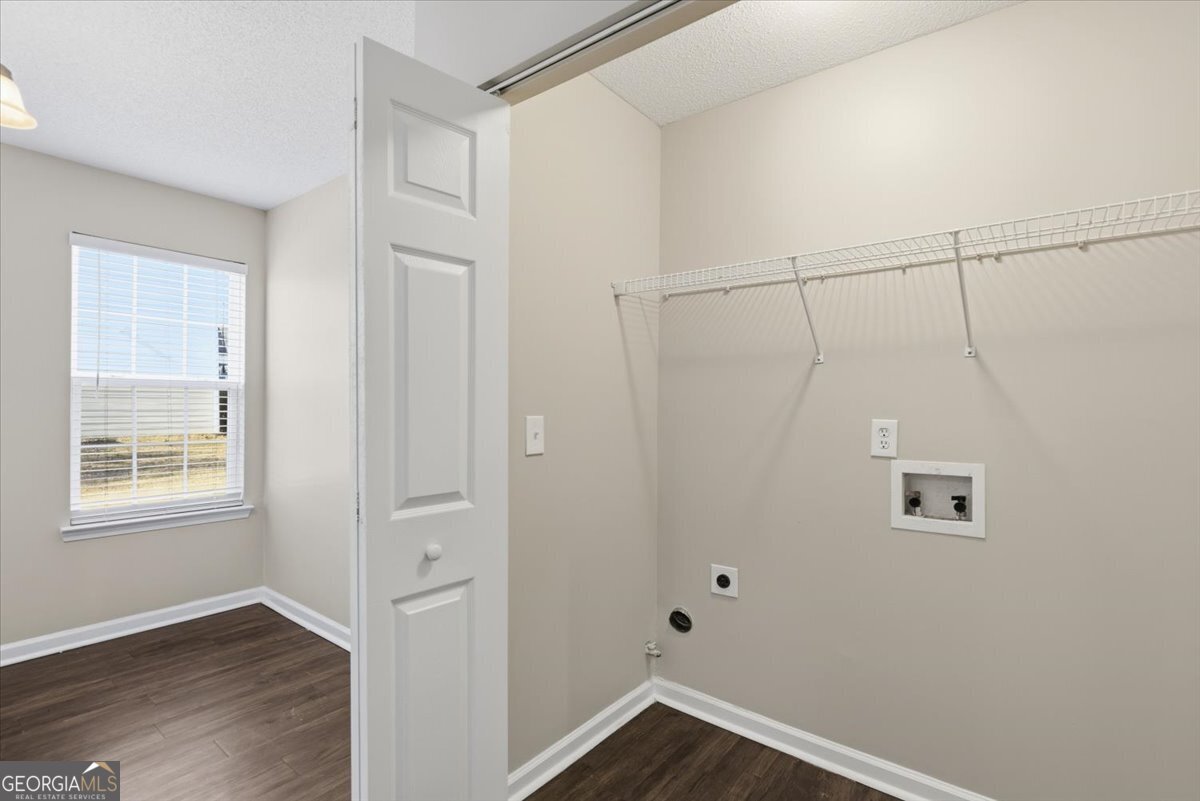 946 Damson Trail Hampton, GA 30228 - Photo 18 of 37 a view of an empty room with wooden floor and a window