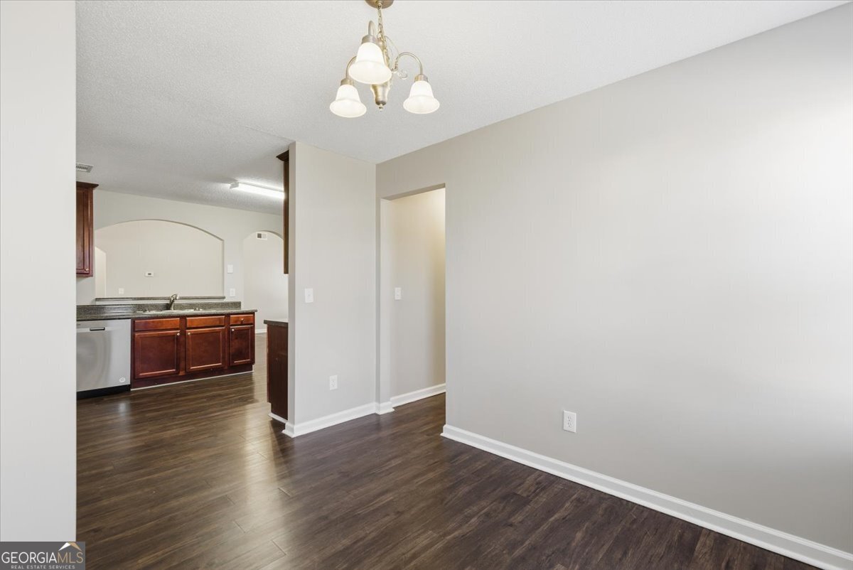 946 Damson Trail Hampton, GA 30228 - Photo 19 of 37 a view of a kitchen with a sink and a stove top oven