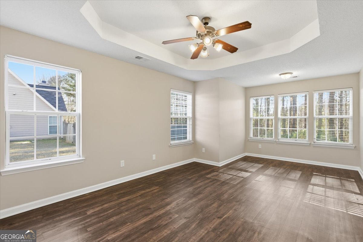 946 Damson Trail Hampton, GA 30228 - Photo 20 of 37 a view of an empty room with a window and wooden floor