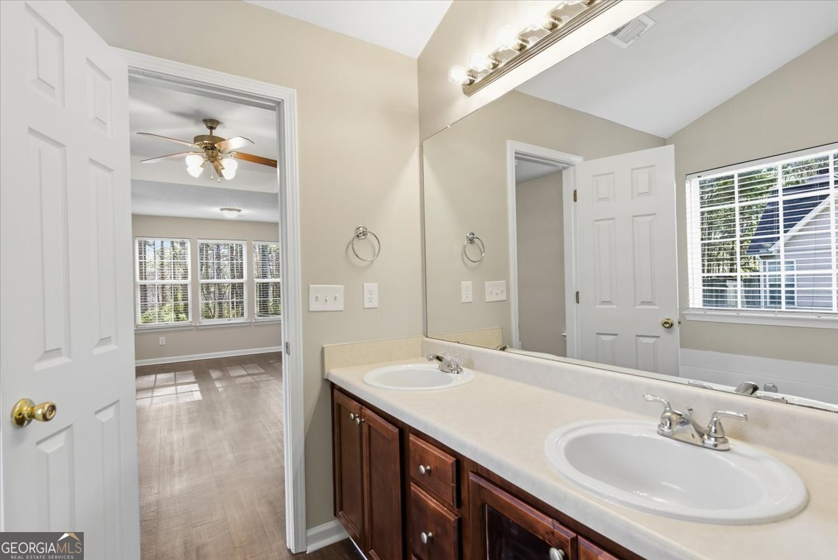 946 Damson Trail Hampton, GA 30228 - Photo 23 of 37 a bathroom with a sink double vanity and a mirror