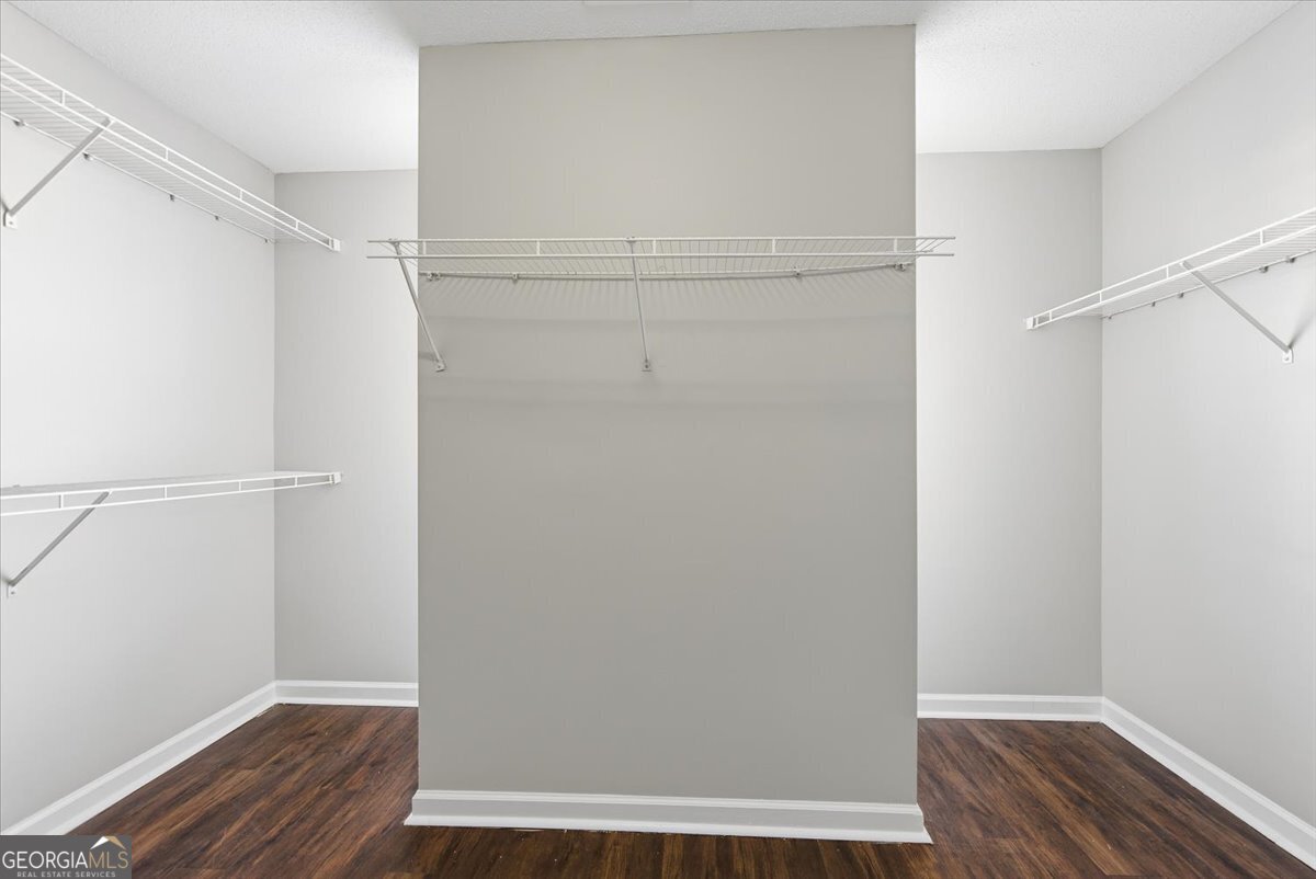 946 Damson Trail Hampton, GA 30228 - Photo 26 of 37 a view of walk in closet with wooden floor