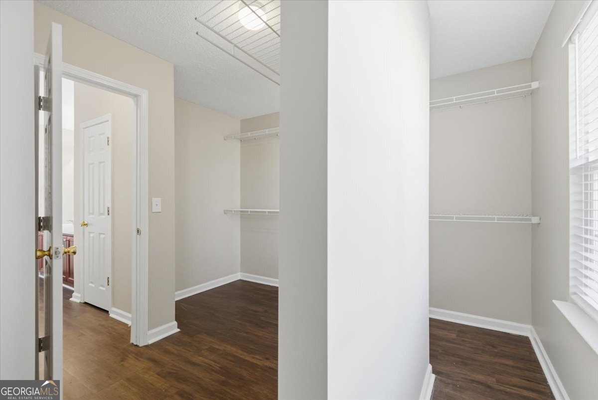 946 Damson Trail Hampton, GA 30228 - Photo 27 of 37 a view of a hallway with wooden floor