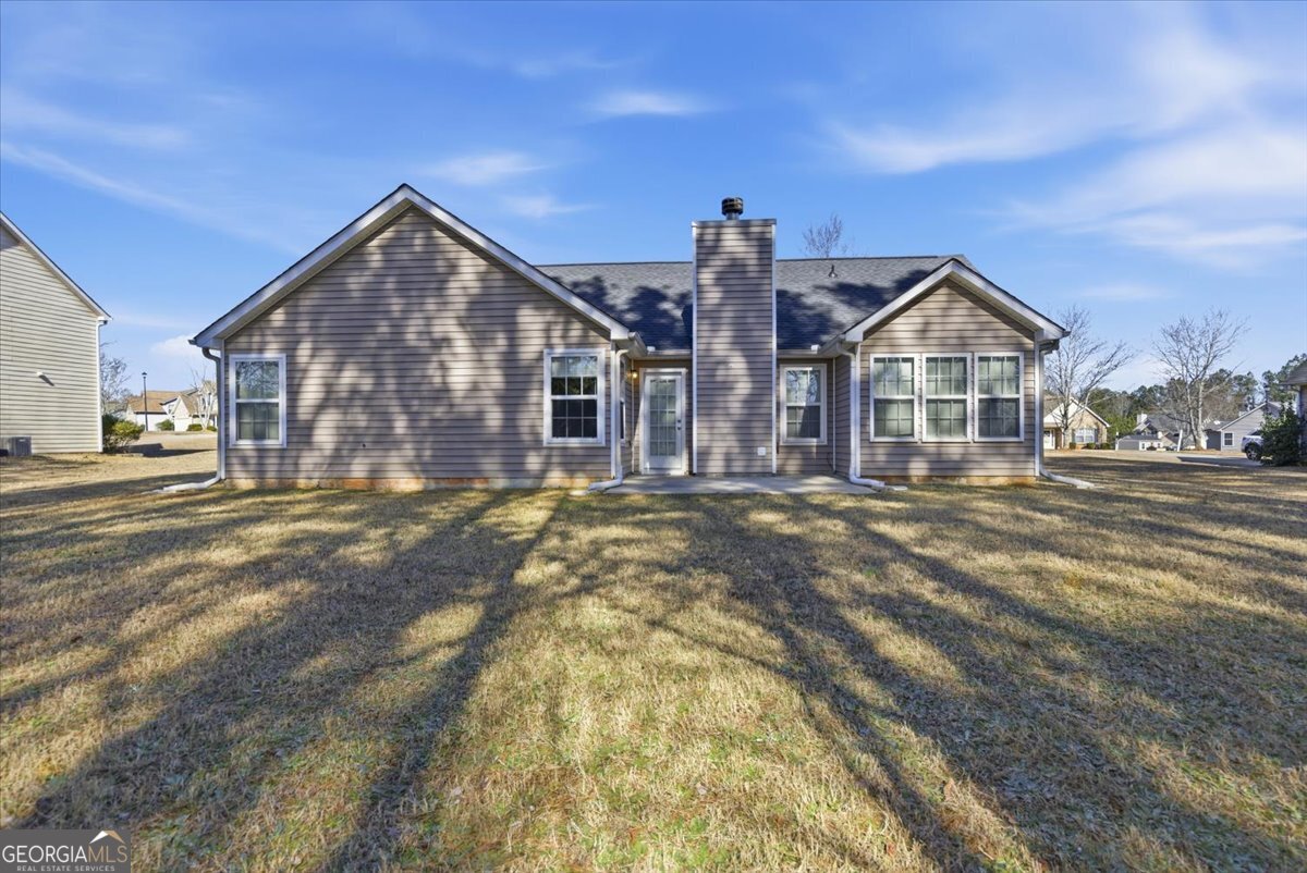 946 Damson Trail Hampton, GA 30228 - Photo 35 of 37 a front view of a house with a yard