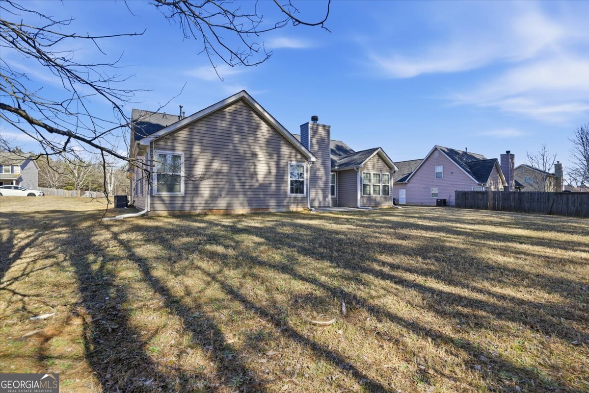946 Damson Trail Hampton, GA 30228 - Photo 36 of 37 a view of a house with a yard