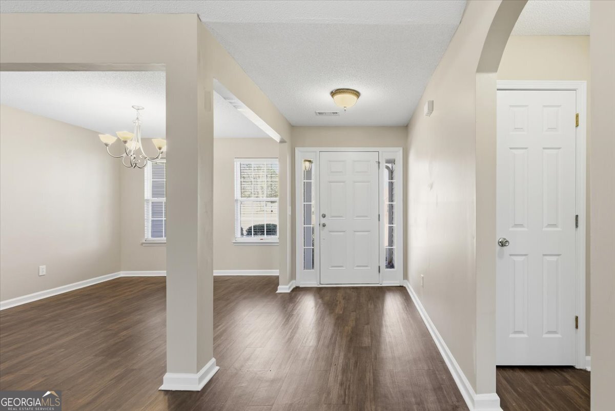 946 Damson Trail Hampton, GA 30228 - Photo 6 of 37 wooden floor in an empty room with a window