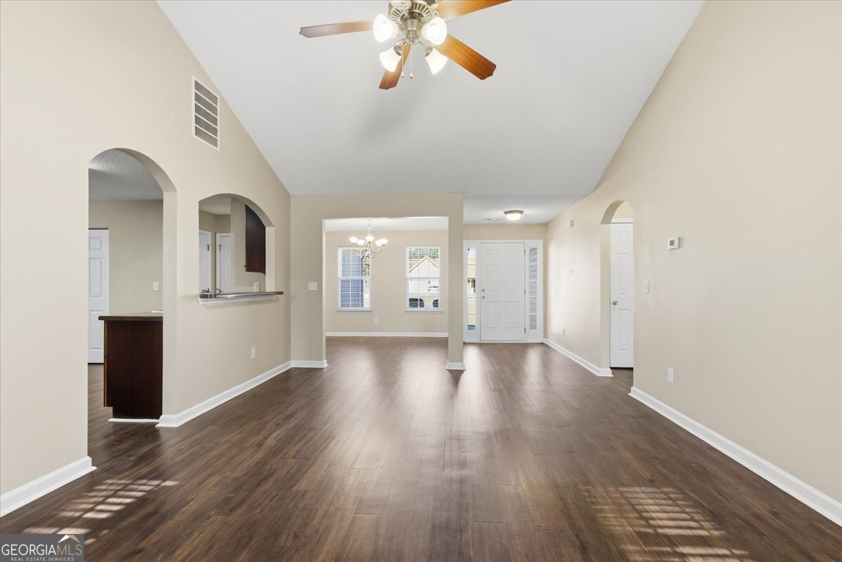 946 Damson Trail Hampton, GA 30228 - Photo 10 of 37 a view of a kitchen with wooden floor and a kitchen space