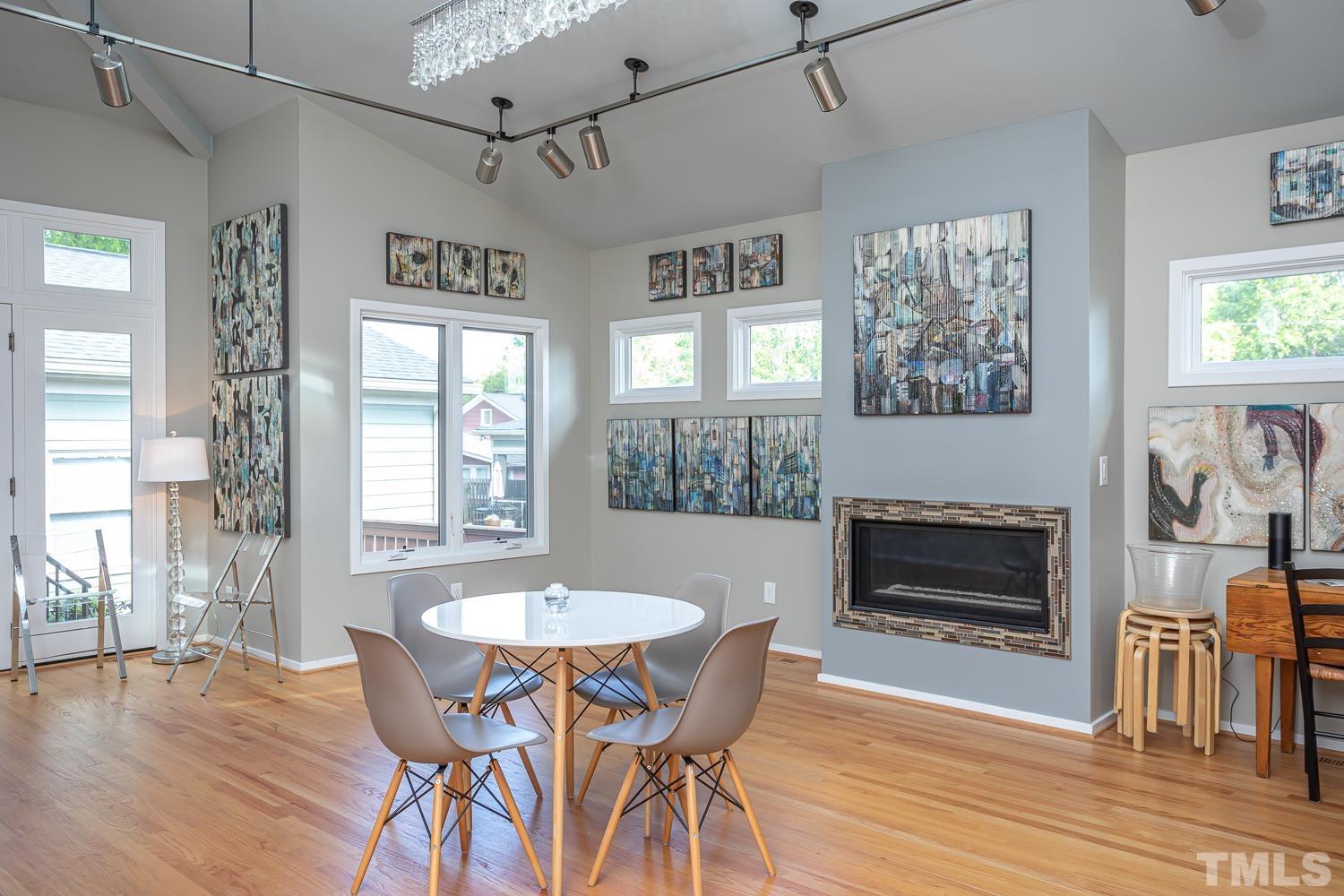 601 Leonidas Court Raleigh, NC 27604 - Photo 24 of 53 a dining room with furniture a fireplace and wooden floor