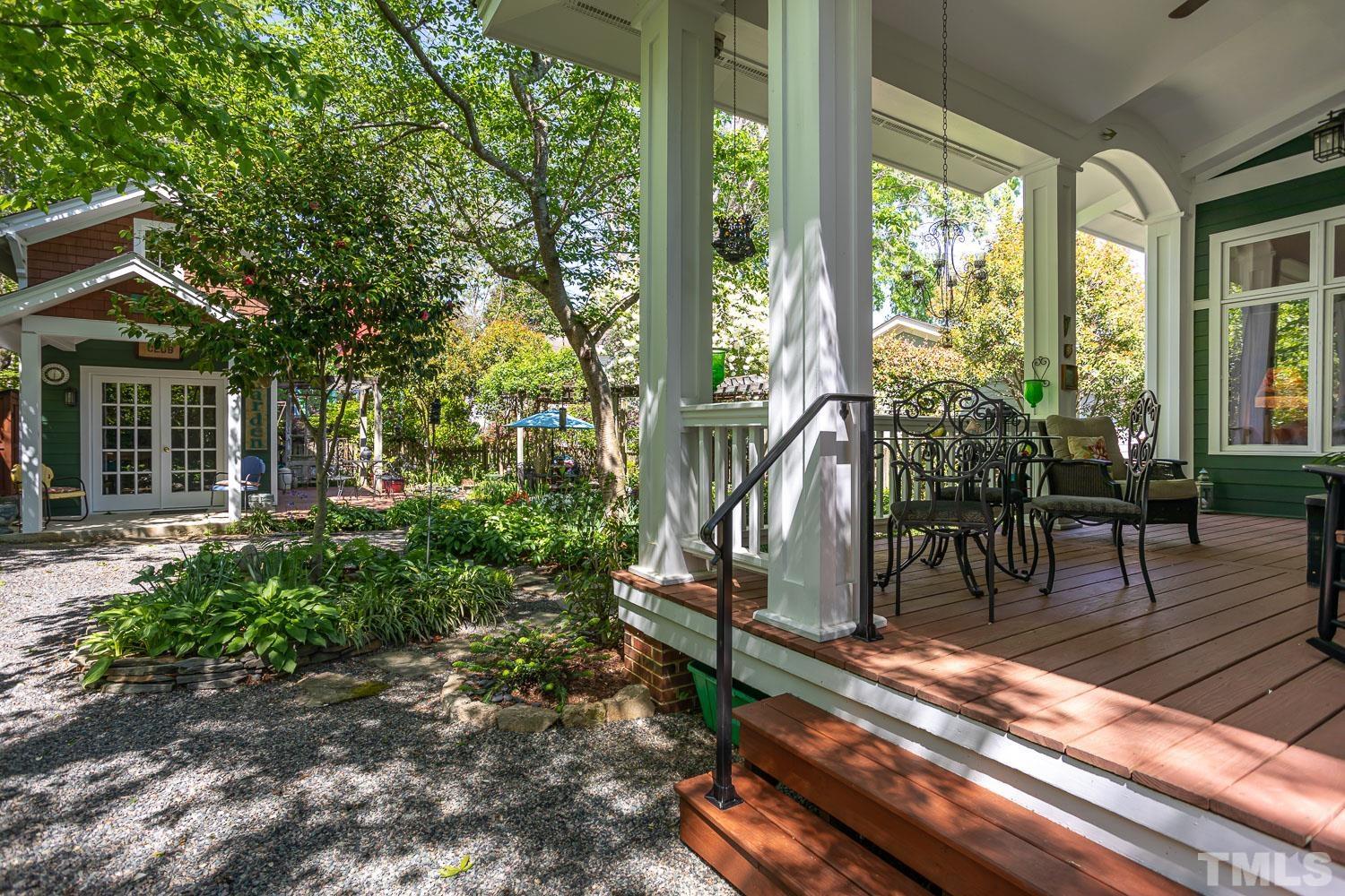 601 Leonidas Court Raleigh, NC 27604 - Photo 36 of 53 a view of a patio with table and chairs potted plants and floor to ceiling window