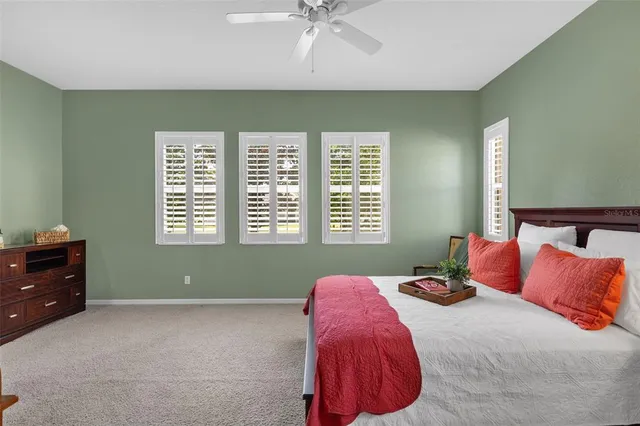 a bathroom with a granite countertop sink a toilet a mirror a vanity and shower