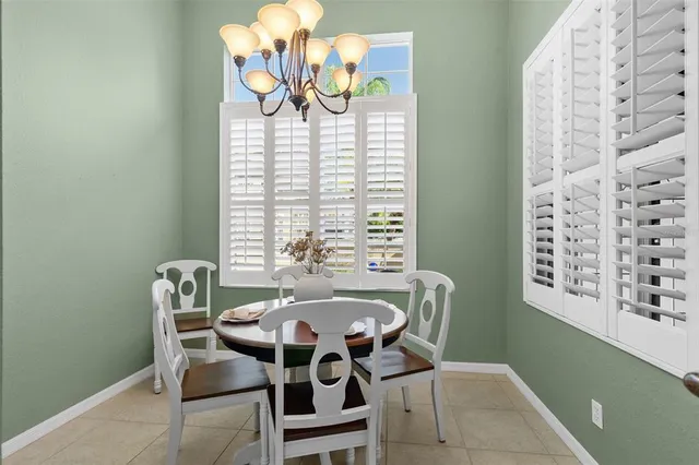 an aerial view of a house with a yard and lake