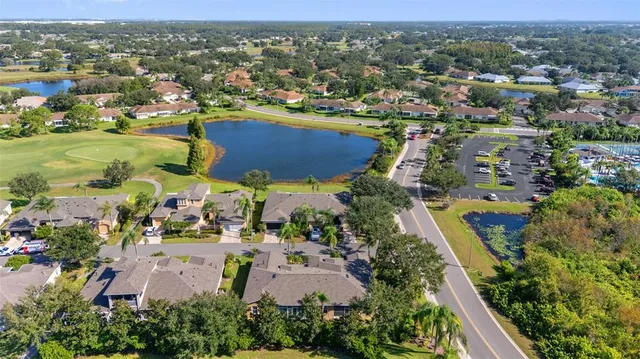 an aerial view of residential houses with outdoor space and swimming pool
