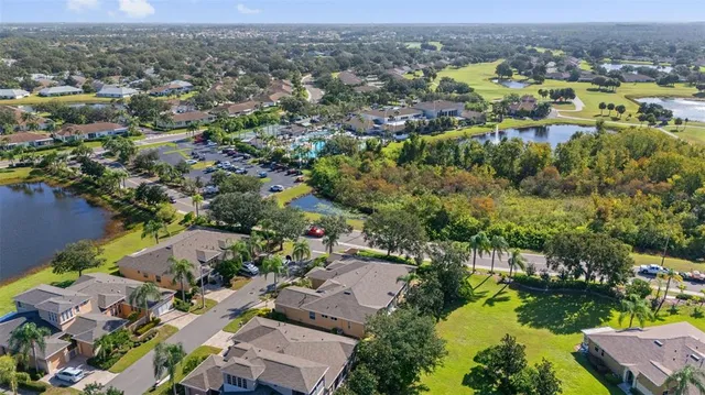 an aerial view of residential houses with outdoor space and swimming pool