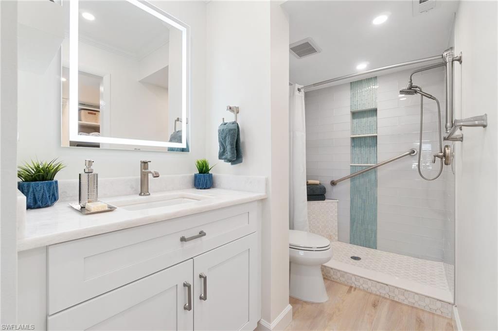 5975 Bloomfield Circle, Unit C108 Naples, FL 34112 - Photo 29 of 50 Stunning marble countertops, white shaker cabinets, shower fog-free mirrors