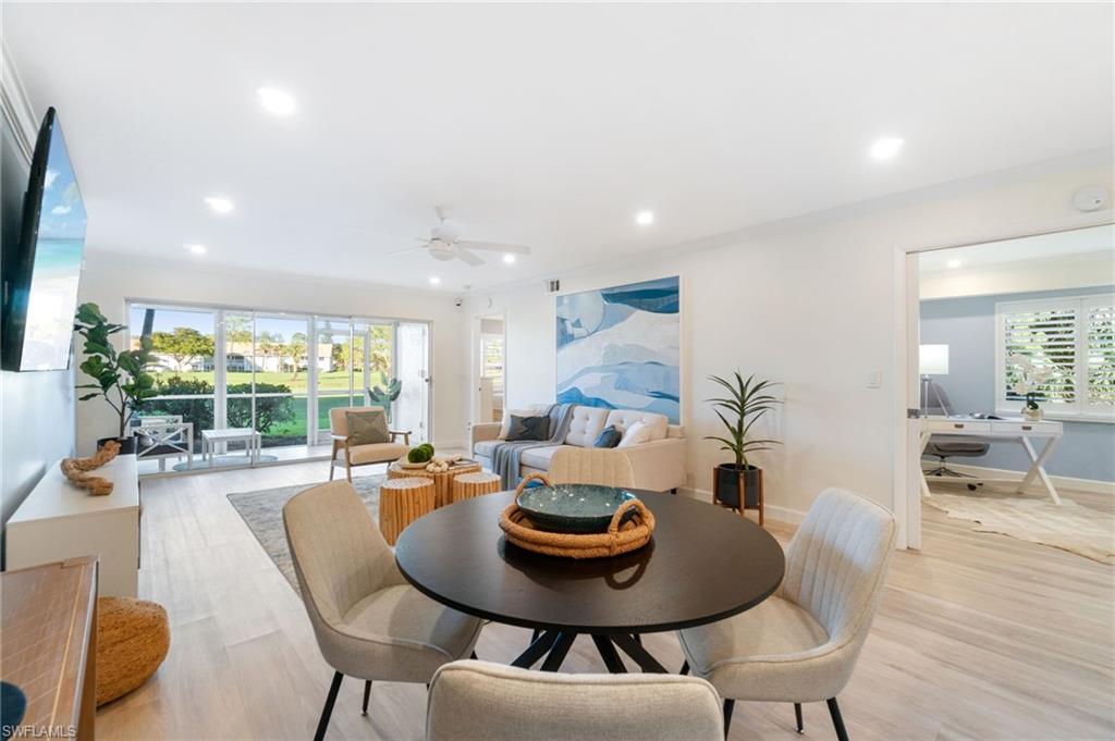5975 Bloomfield Circle, Unit C108 Naples, FL 34112 - Photo 8 of 50 Dining area looking out through the main living space to the beautiful views of the lush golf course. This unit is light and bright. Freshly painted throughout and luxury vinyl throughout
