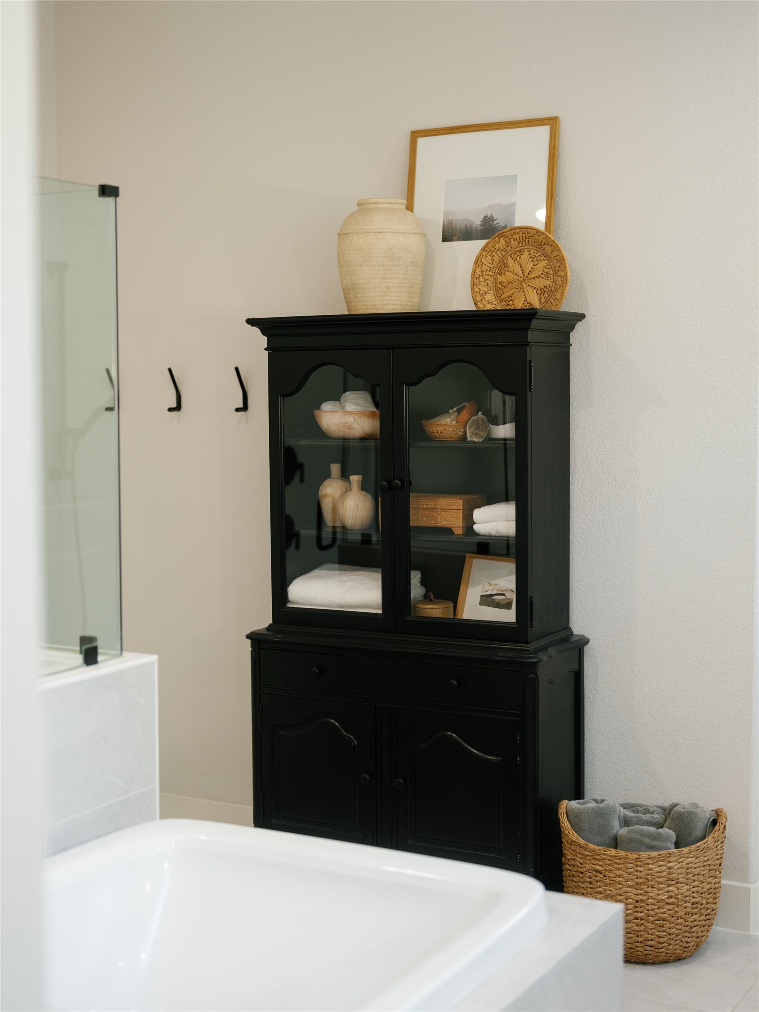 145 Eagle Pass Trail Georgetown, TX 78628 - Photo 19 of 37 Luxurious soaking tub and sleek storage cabinet elevate this serene bathroom's charm.