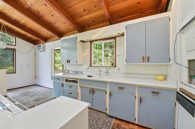 a kitchen with stainless steel appliances granite countertop a sink and a stove