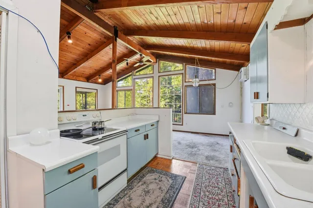 a kitchen with a sink stove and cabinets