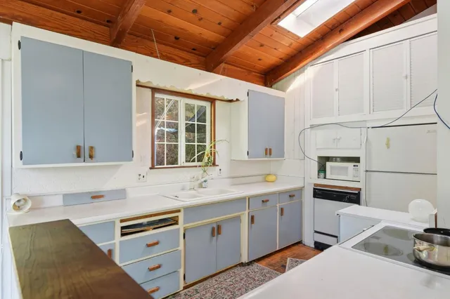 a kitchen with a sink appliances and cabinets