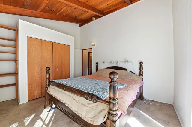 a bedroom with a large bed and a window