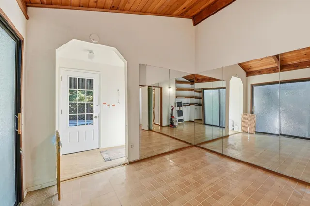 a view of a house with a large window and wooden floor